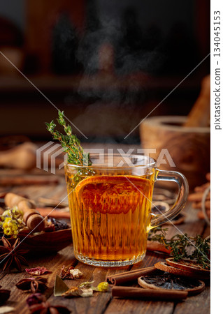 Herbal tea with thyme and dried orange slice. 134045153