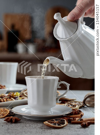 Herbal tea is poured into a cup. 134045157