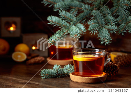 Tea with lemon and small Christmas lanterns on a wooden table. Tea with lemon and small Christmas lanterns on a wooden table. 134045167
