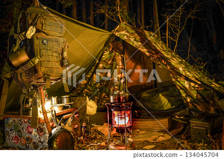 Camping with military backpacks, military tents and lanterns Camping with military backpacks, military tents and lanterns 134045704