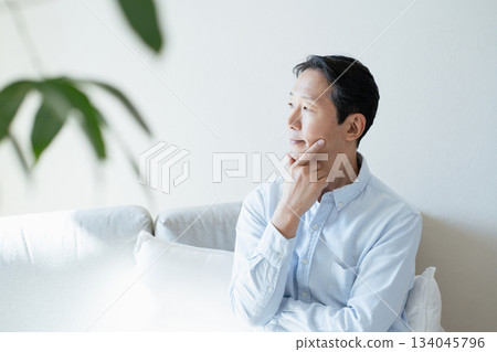 Middle-aged man thinking on the sofa 134045796