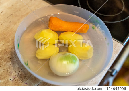 Fresh vegetables in water prepare for cooking in a kitchen setting 134045906