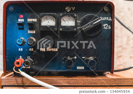 Device for charging batteries with controls and meters seen close up in workshop 134045934