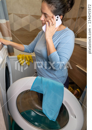 Calling an Appliance Repair Service for a Faulty Washing Machine 134045972