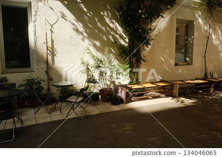Sunlit Courtyard Garden With Wrought Iron Sunlit Courtyard Garden With Wrought Iron 134046065