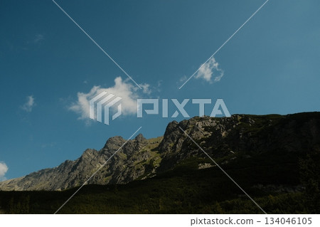 Dramatic Mountain Peaks Against Azure Sky Dramatic Mountain Peaks Against Azure Sky 134046105