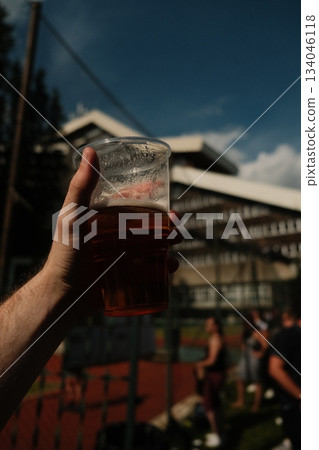 Hand Holding Refreshing Drink At Summer Event 134046118