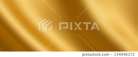 Gold foil background with golden metal shine and soft gradient texture. This gold foil surface adds a glossy golden look, creating a luxurious metal effect for elegant designs 134046172