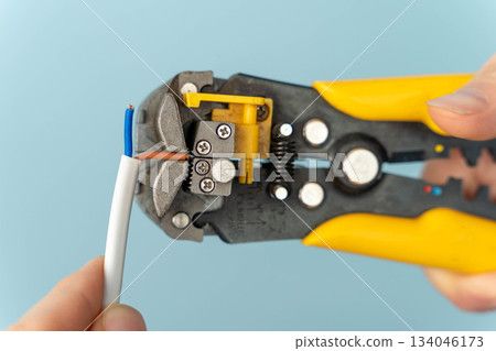 Tool used for stripping wire in a hand during home improvement project 134046173
