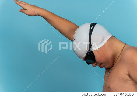 Young swimmer prepares for practice at the swimming pool before an event 134046190