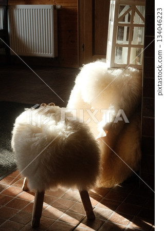 Fluffy Sheepskin Rug on Wooden Rail Fluffy Sheepskin Rug on Wooden Rail 134046223