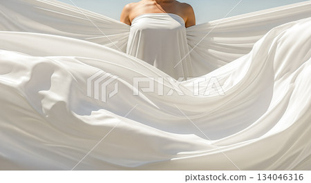 Young woman holding flying white silk fabric wind blue sky background freedom purity freshness elegance fashion soft textile material motion Young woman holding flying white silk fabric wind blue sky background freedom purity freshness elegance fashion soft textile material motion 134046316