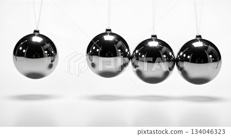 Silver newton cradle balls hanging isolated on white background concept physics science momentum balance energy motion kinetic pendulum 134046323