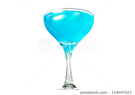 A tall, thin glass filled with a blue liquid 134047021