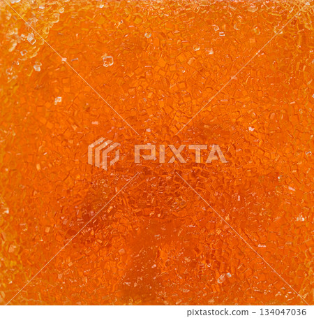A close up of a yellow substance with a grainy marmalade texture 134047036