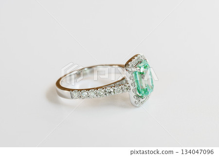 A green and white ring with diamonds and a halo A green and white ring with diamonds and a halo 134047096