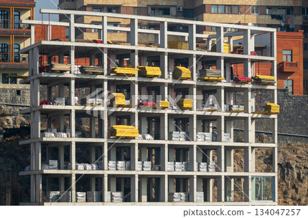 Yerevan Armenia 10.25.2025. A large building with a lot of scaffolding and yellow boards on the side Yerevan Armenia 10.25.2025. A large building with a lot of scaffolding and yellow boards on the side 134047257