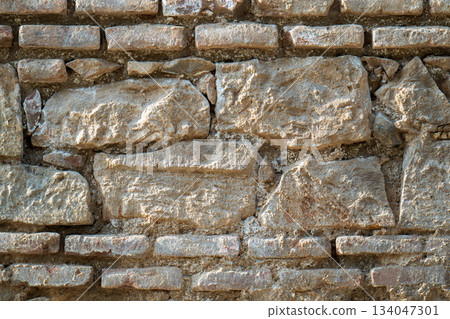 A wall made of stone with a rough texture A wall made of stone with a rough texture 134047301