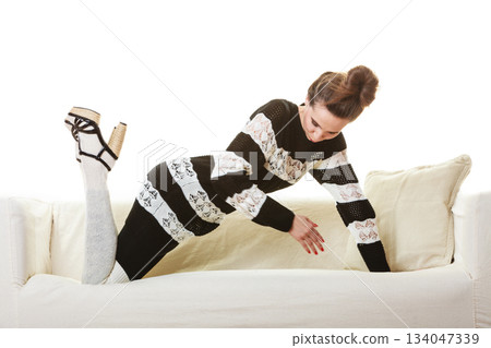 Girl fashionable dress high heels posing on couch. Girl fashionable dress high heels posing on couch. 134047339
