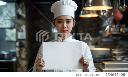 Japanese female chef holding up a white piece of paper 134047406