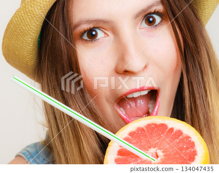Summer girl tourist holding grapefruit citrus fruit 134047435