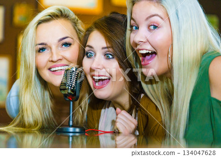 Women singing with microphone Women singing with microphone 134047628