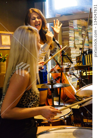 Woman singing, band playing instruments. Woman singing, band playing instruments. 134047631