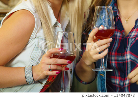 Girls with alcohol glass in pub club 134047878