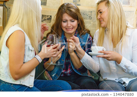 Sad woman crying and being consoled by friend. Sad woman crying and being consoled by friend. 134047880