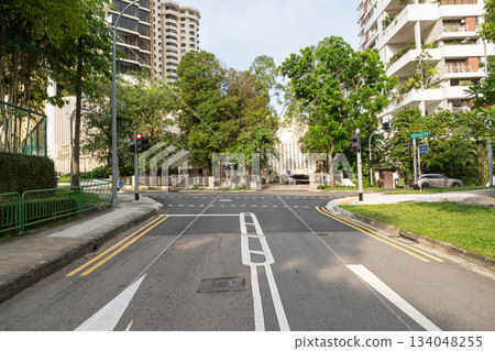 Orchard Road intersection with traffic lights and lush greenery in Singapore Orchard Road intersection with traffic lights and lush greenery in Singapore 134048255