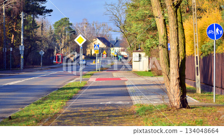 Quiet street in a residential area in the suburbs. Sidewalk and bike path. Quiet street in a residential area in the suburbs. Sidewalk and bike path. 134048664