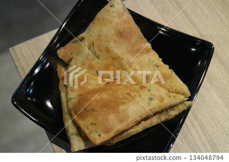 Black scallion pancake Black scallion pancake 134048794