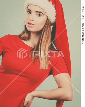 Woman wearing Santa Claus helper costume 134049379