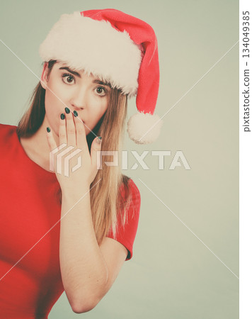 Shocked woman wearing Santa Claus helper costume Shocked woman wearing Santa Claus helper costume 134049385