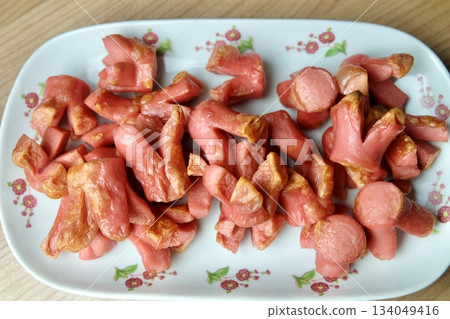 Fried Sausages Cut Flower Shape on Wooden Table Fried Sausages Cut Flower Shape on Wooden Table 134049416