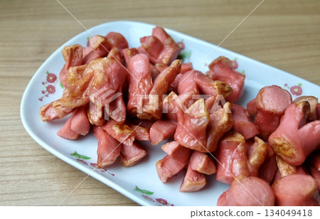 Fried Sausages Cut Flower Shape on Wooden Table 134049418