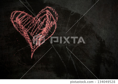 Chalk a heart on a dark surface for digital Valentine's Day content. 134049528