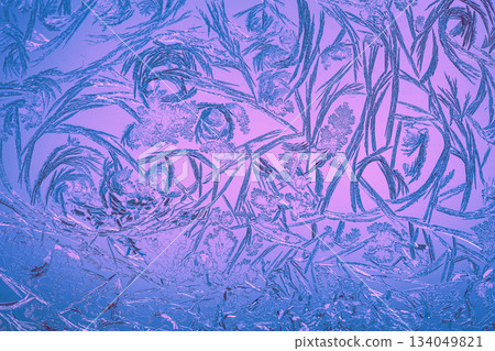 Natural ice texture on the frozen window in purple light. Christmas background Natural ice texture on the frozen window in purple light. Christmas background 134049821