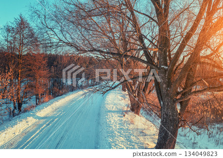 Country road covered with snow in the winter evening. View from above Country road covered with snow in the winter evening. View from above 134049823