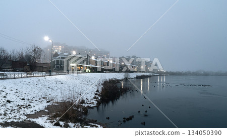 Foggy Winter Evening by the Lake with City Lights, Ukraine Foggy Winter Evening by the Lake with City Lights, Ukraine 134050390