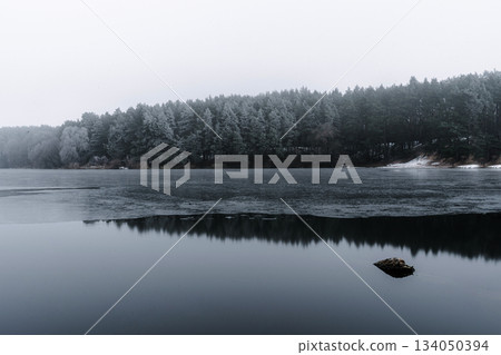 Winter Lake Reflections in Quiet Foggy Forest Winter Lake Reflections in Quiet Foggy Forest 134050394