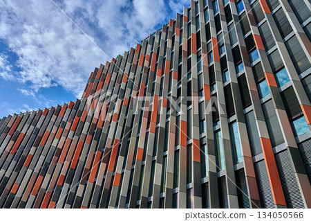 Modern geometric facade of multicolored urban building with vertical panels Modern geometric facade of multicolored urban building with vertical panels 134050566