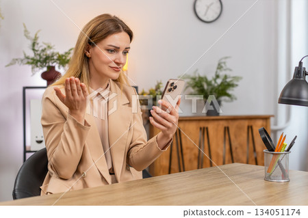 Businesswoman reads credit refusal on smartphone bad news game loss sighs disappointed reaction look 134051174
