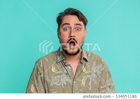 Adult man raising eyebrows opening mouth widening eyes in sudden surprise shock with extreme emotion 134051190