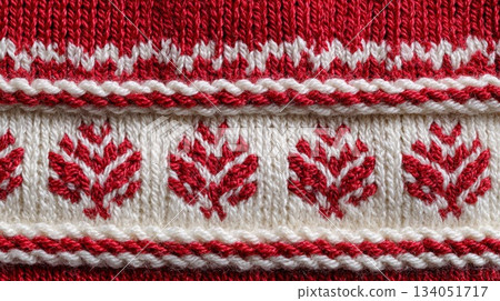 Red knitted fabric with intricate white leaf patterns, showcasing traditional textile craftsmanship Red knitted fabric with intricate white leaf patterns, showcasing traditional textile craftsmanship 134051717
