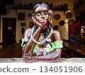 Ceramic doll painted in bright colors depicting the bust of an afro brazilian woman, Brazil 134051906