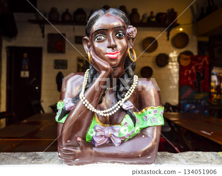 Ceramic doll painted in bright colors depicting the bust of an afro brazilian woman, Brazil 134051906