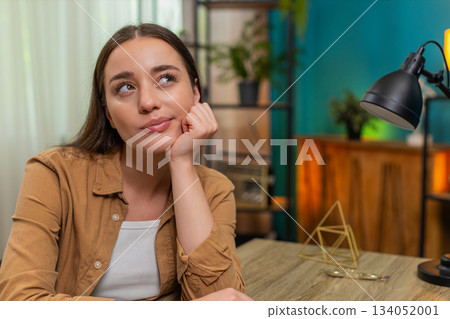 Young woman close up resting chin on hand thinking hard about solution looking for creative answer Young woman close up resting chin on hand thinking hard about solution looking for creative answer 134052001