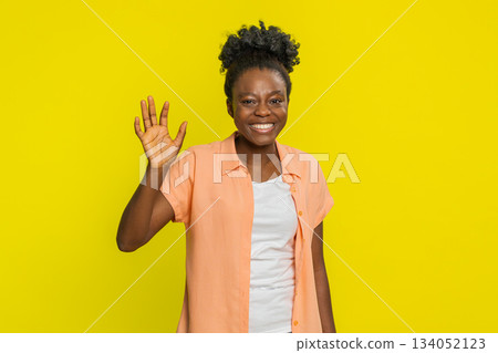 Happy woman smiling friendly waving hands gesturing hello greeting or goodbye, meeting invitation Happy woman smiling friendly waving hands gesturing hello greeting or goodbye, meeting invitation 134052123