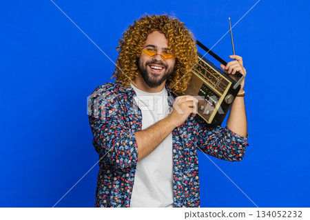 Happy man listening music on retro tape record player disco dancing fan of vintage technologies 134052232